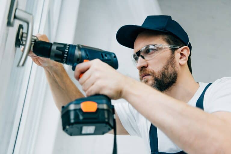 adult-repairman-in-goggles-fixing-window-handle-by-electric-drill-e1663969255653-768x513